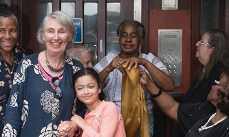 Residents outside a front door of a block of flats