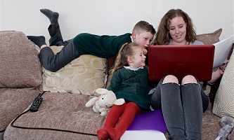 Lady with children using a laptop