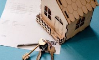 A picture of a model house, keys and piece of paper