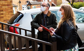 settle colleagues outside a resident's house asking questions as part of the Big Door Knock