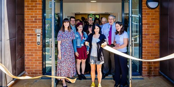 Resident Nadine cuts the ribbon at Kingfisher House in John Barker Place