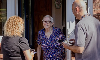 Two Settle colleagues talking a resident on her doorstep during the Big Door Knock.