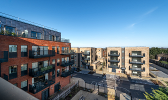 Apartment buildings at John Barker Place in Westmill, Hitchin, on a sunny day