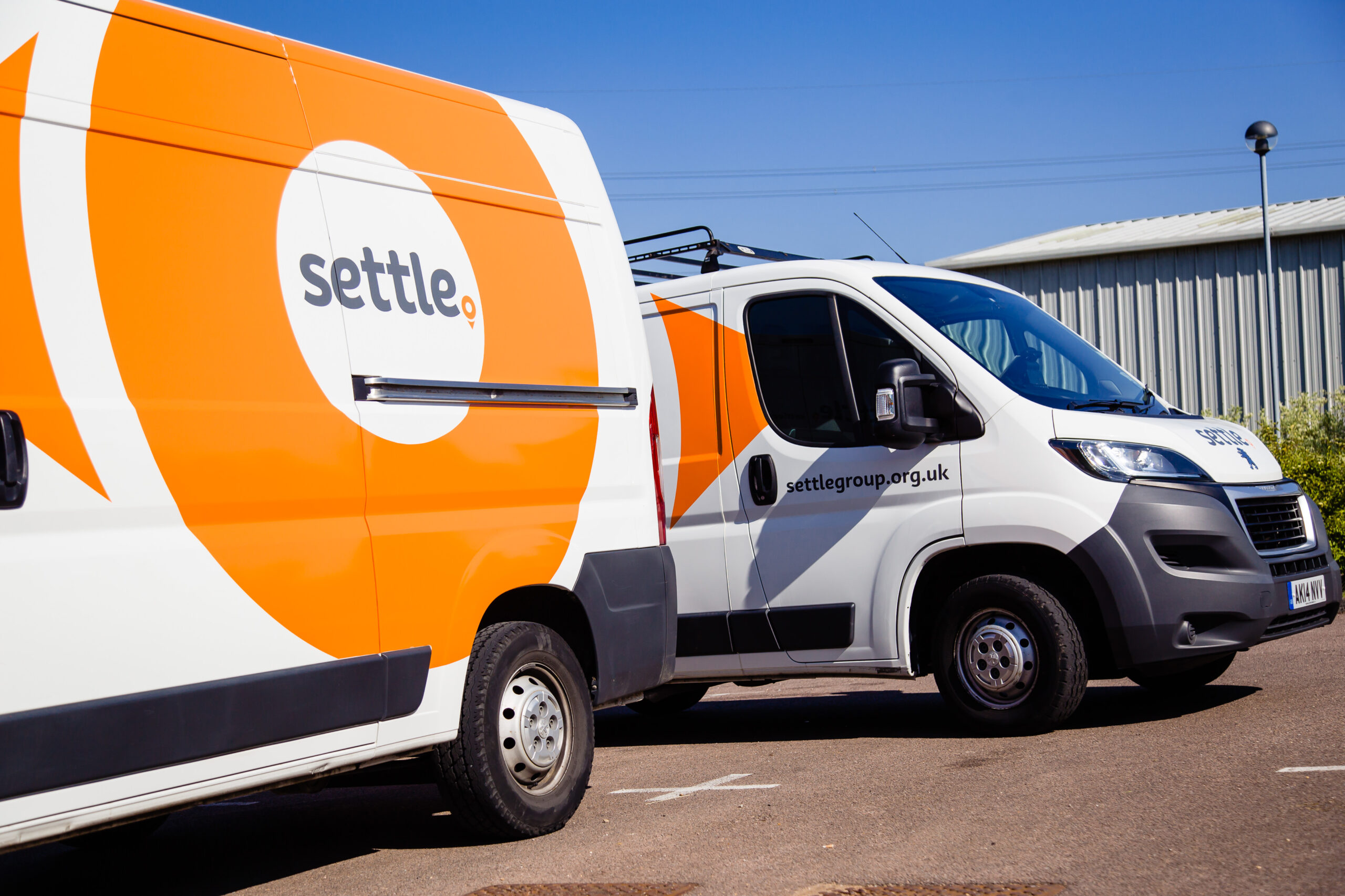 Two Settle vans parked in a car park.