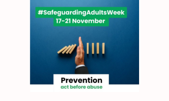 A hand stops falling wooden dominoes on a blue background. Text reads: “#SafeguardingAdultsWeek 17–21 November” and “Prevention – act before abuse. Safeguarding Adults Week 2025.”