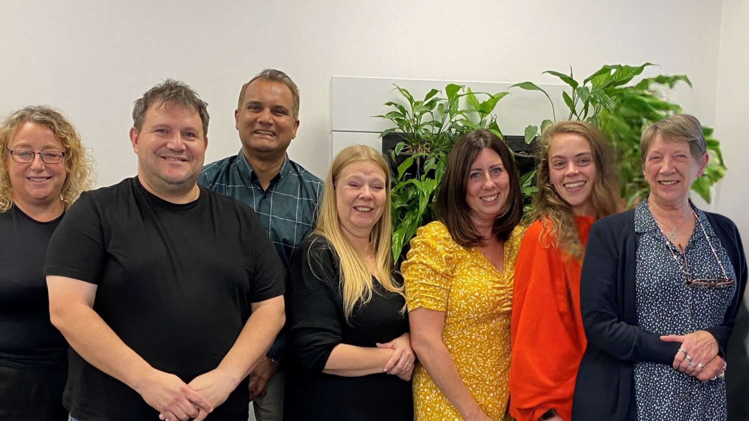 Members of the VoR panel in a line posing for a photograph inside an office space.