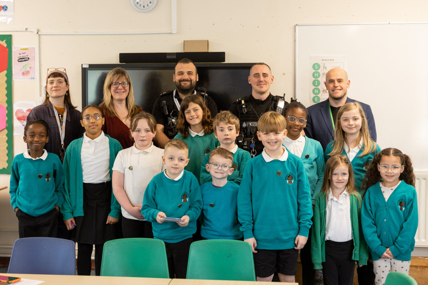 Group photo of Garden City Academy Pupil Parliament pupils with Settle colleagues, police representatives and a local councillor in a classroom.