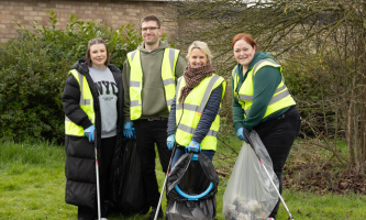 Settle colleagues wearing high‑visibility vests take part in a community litter pick.