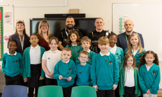 Group photo of Garden City Academy Pupil Parliament pupils with Settle colleagues, police representatives and a local councillor in a classroom.