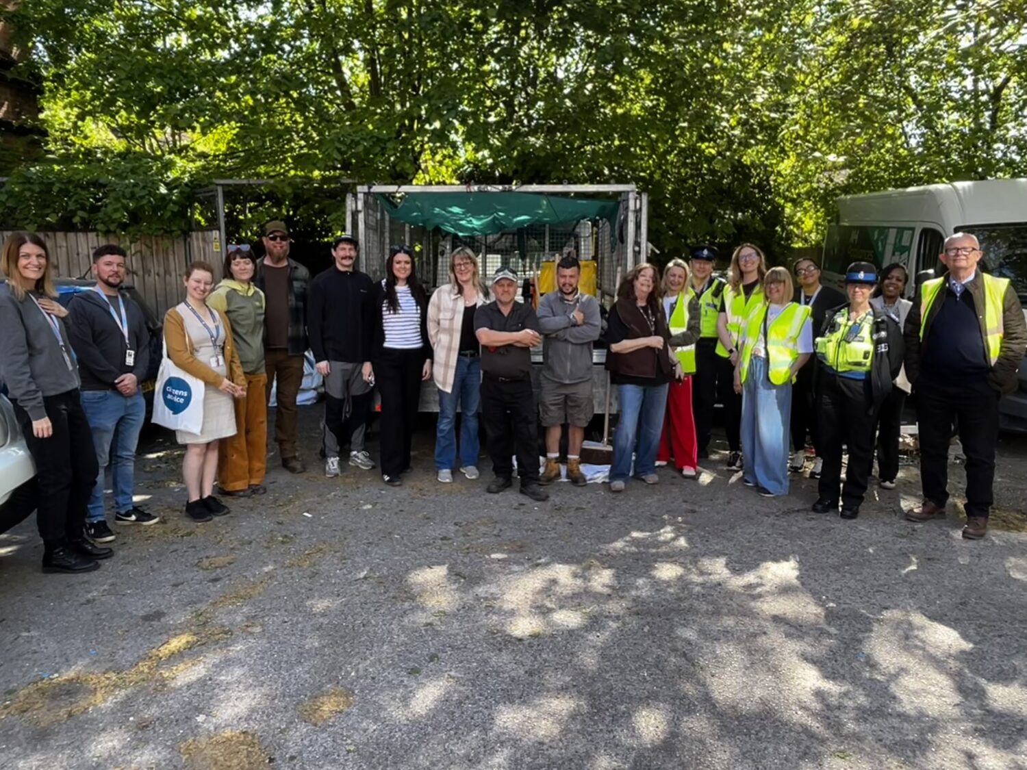 Settle colleagues with partners at Moselle House in Watford standing in a line in front of a Settle truck with bags of rubbish.